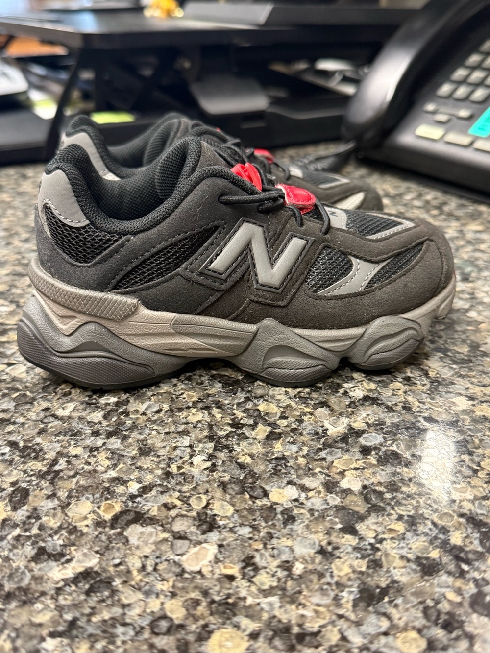 New Balance Kids Black and Gray Sneakers with Red Accents